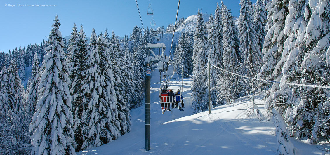 View from chairlift among snow-covered trees above Samoens