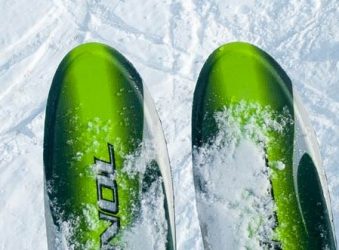 View from chairlift of two pairs of skis, with skier below