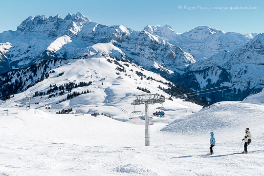 Overview of two skiers descending mountainside at Les Crozets, Portes du Soleil