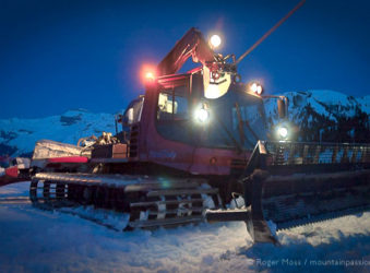 Night view of piste groomer above Samoens, Grand Massif, French Alps.
