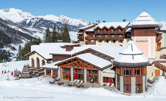 Skiers beside Club Med resort, Valmorel, French Alps