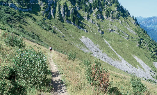 View of walker on mountain footpath in Summer above Chatel