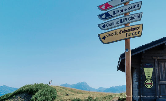 Low view of footpath sings and walker on path above Chatel