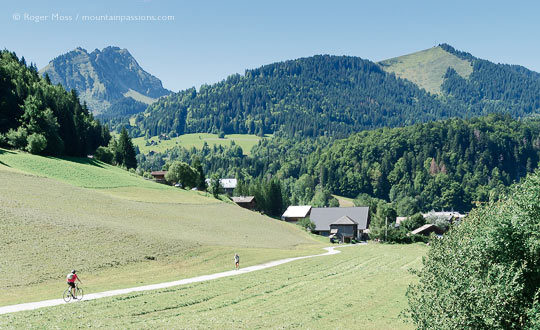 Summer view of cyclist and walker on track near Abondance, French Alps