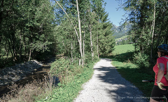 Bike rider beside cycle route and footpath with river