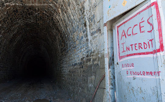 View into interior of unlit stone tunnel du Parpaillon