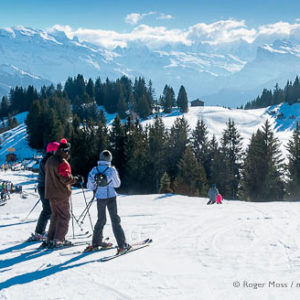 Skiers looking at mountain scenery above Les Gets, French Alps