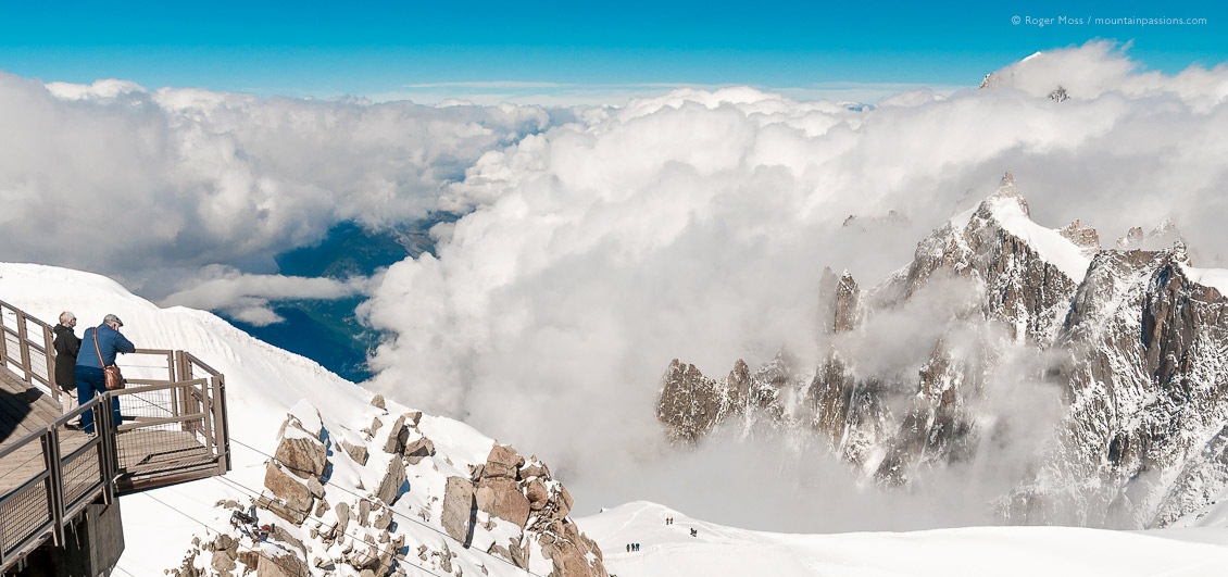 High view of visitors looking at Mont Blanc from observation deck of Aiguille du Midi, high above Chamonix