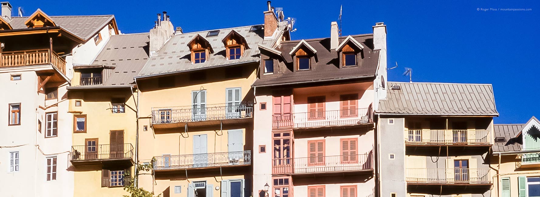 Line of brightly-coloured facades in Briancon, French Alps.