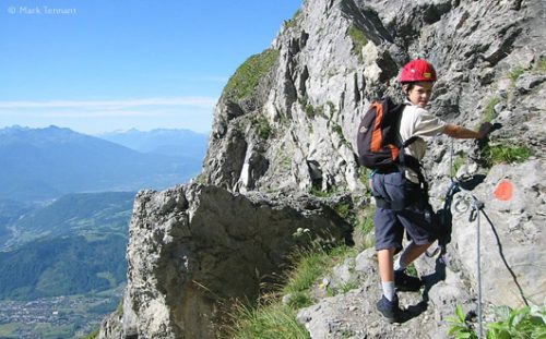 boy on via ferrata route, French Alps