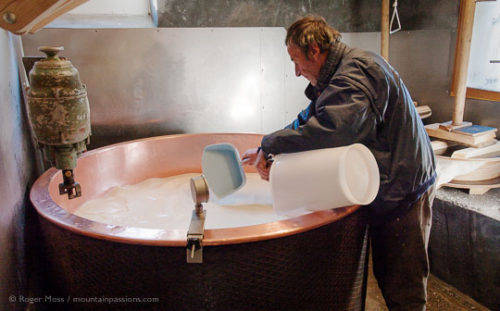Jean-Pierre Blanc checking temperature of milk in copper vat while making Beaufort cheese