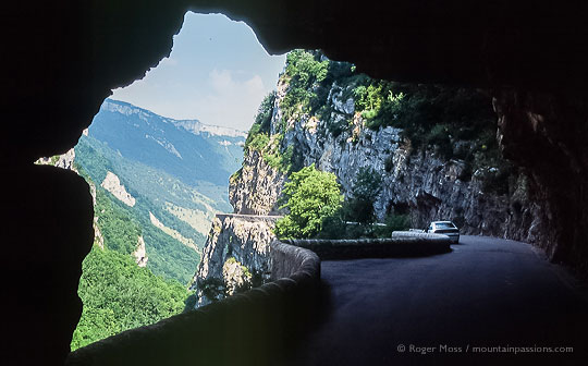 Wide view of mountain road and valley from tunnel exit