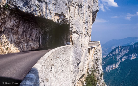 View of high mountain road with rock tunnel and sheer drop