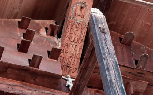 An inscription on chalet roof timbers at Combloux, French Alps.