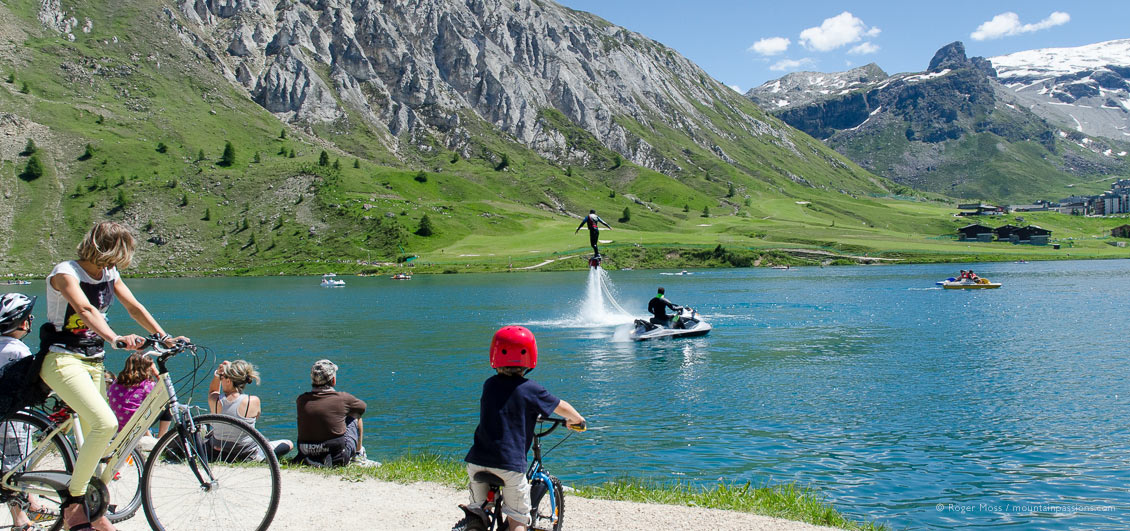 Lakeside view of families watching fly-board demonstration at Tignes