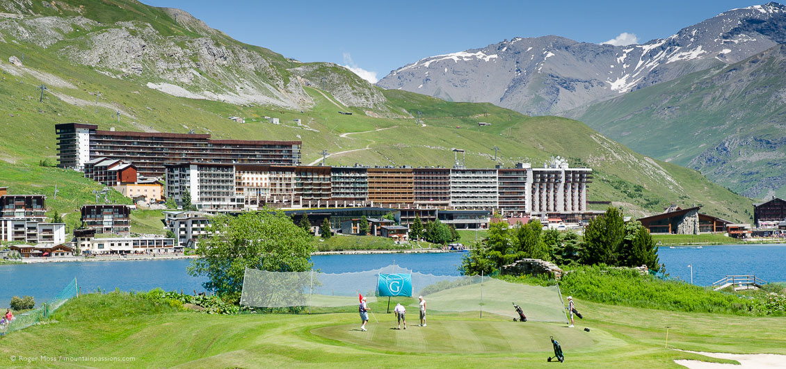 Wide view of Tignes le Lac village beyond lakeside golf course