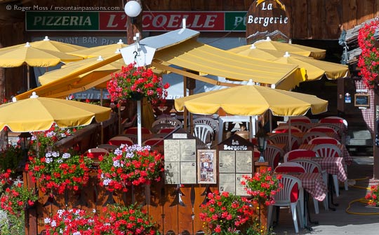 View of pizzeria terrace with parasols and summer flowers