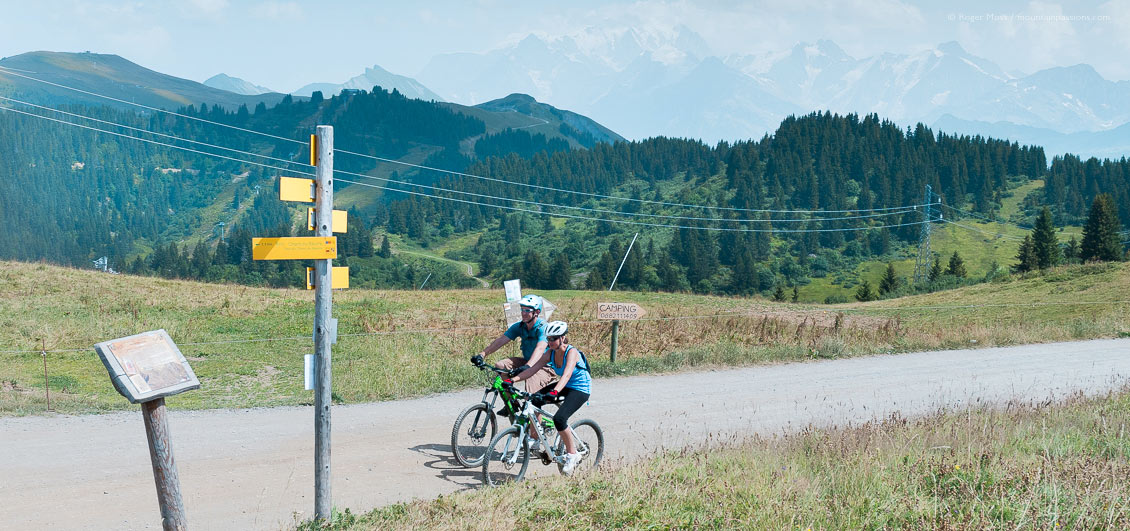 Two mountain bikers on track above Les Saisies with Mont-Blanc