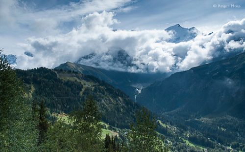 The snow-capped summit of Mont-Blanc appears above the cloud seen from the Mont Blanc Tramway.