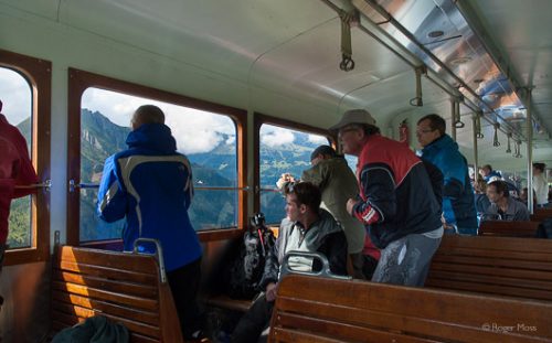 Passengers on the Mont Blanc tram looking at the spectacular mountain scenery.