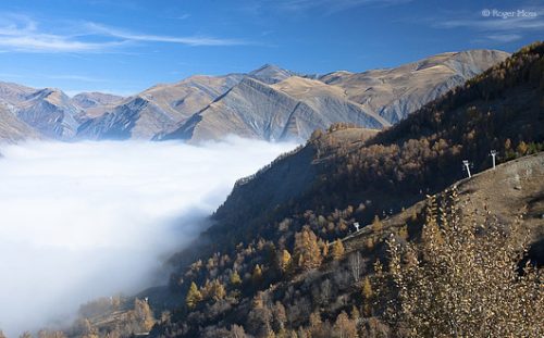 Morning sun disperses overnight mists in the valleys below Les Deux-Alpes.