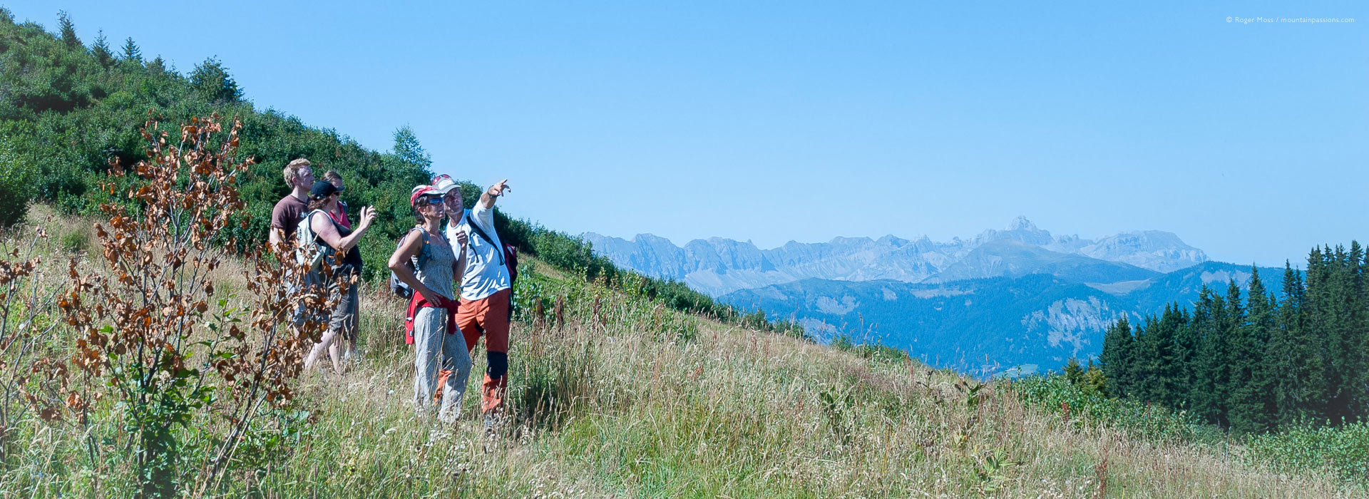 Group of walkers with tour guide Mark Tennent on mountainside in summer