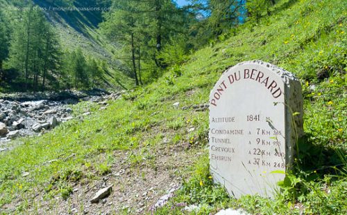 Stone sign at Pont du Berard, beside mountain stream.