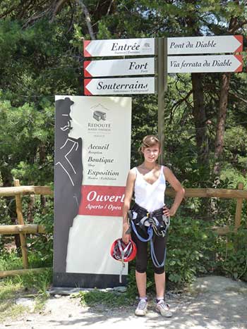 Via Ferrata signage with girl and equipment