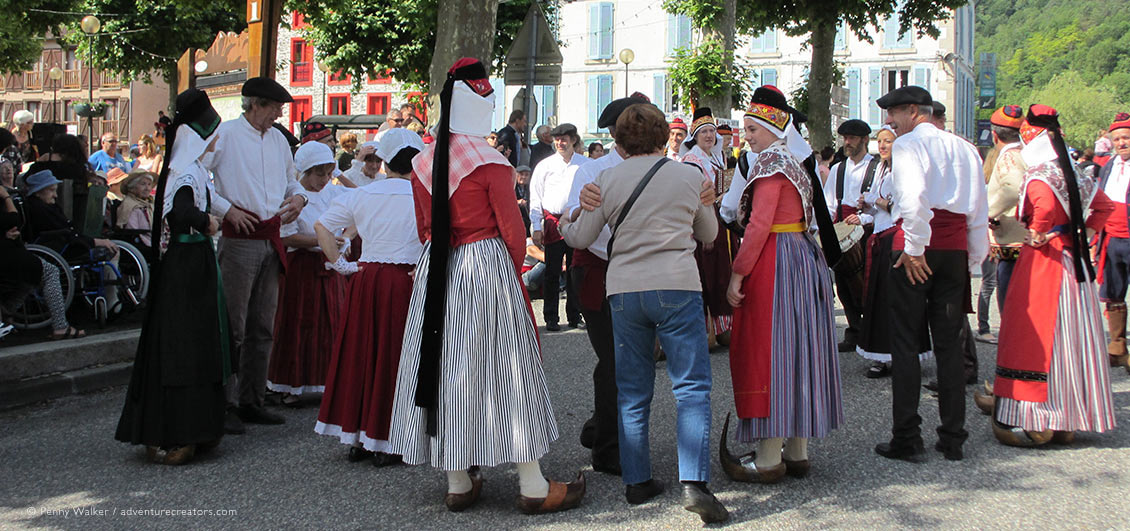 Villagers in traditional costume meeting visitors at Transhumance Festival