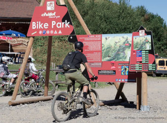 Mountain biker looking at map of Chatel bike park