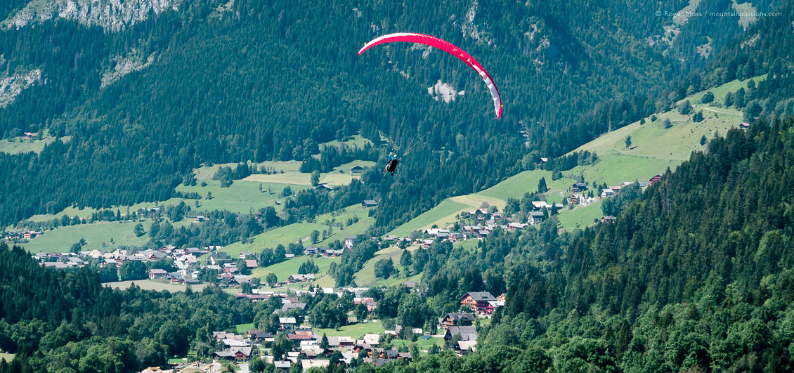Wide view of parapente flight over Chatel village, French Alps.