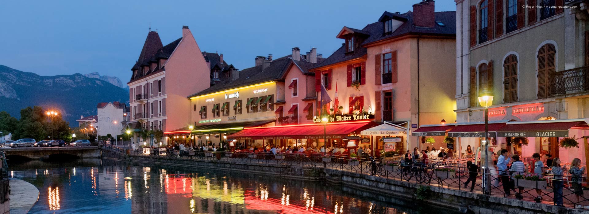 Wide view of quayside restaurants at dusk