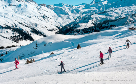 ESF ski instructor with young skiers above Areches Beaufort, French Alps.