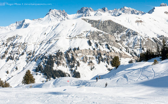 Skiers on piste above Areches Beaufort, French Alps