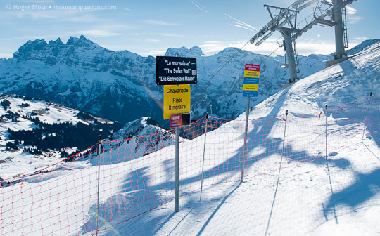 Swiss Wall piste sign, with mountains and ski-lift at Avoriaz, Portes du Soleil, French Alps.