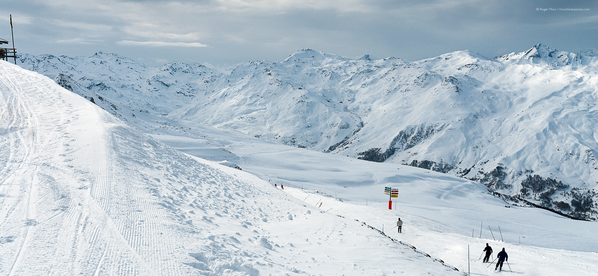 Skiers on piste in 3 Valleys ski area above Brides-les-Bains