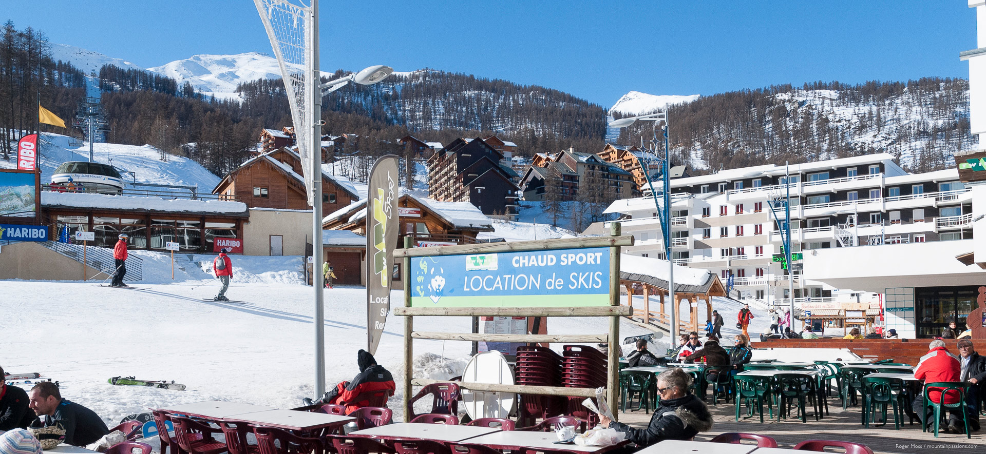 Wide view from cafe terrace, showing village apartments and ski lifts