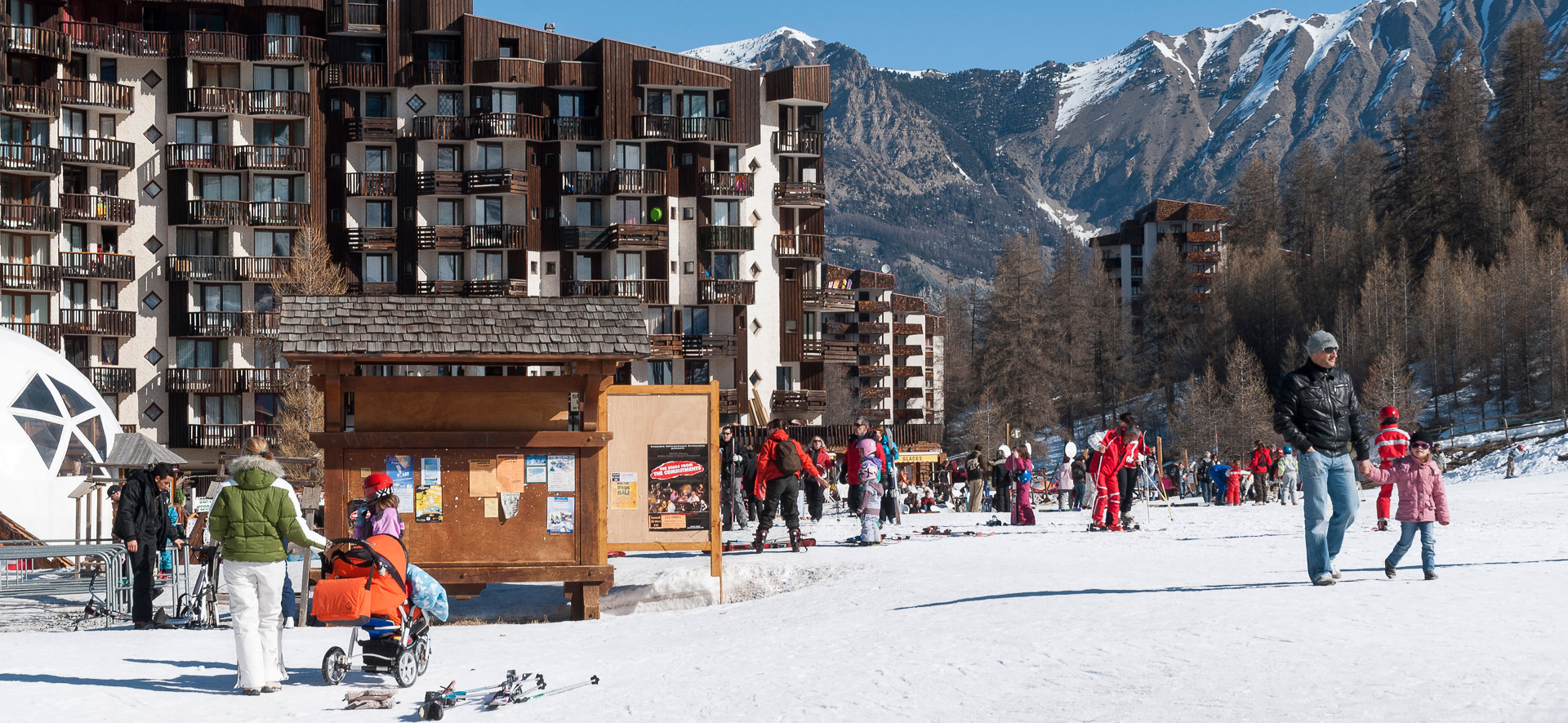 Family skiers in original village centre at Les Orres.