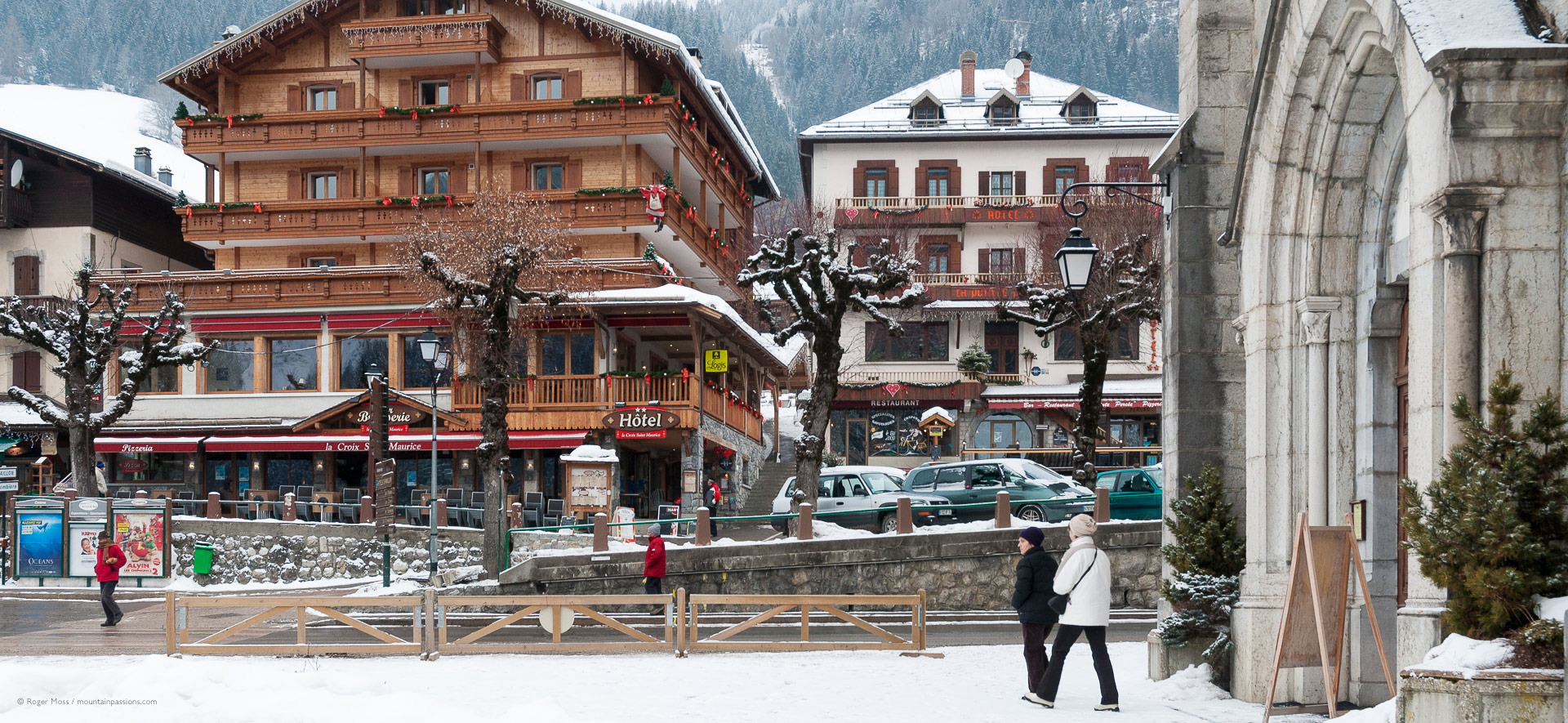 Village church and hotels after snowfalls.