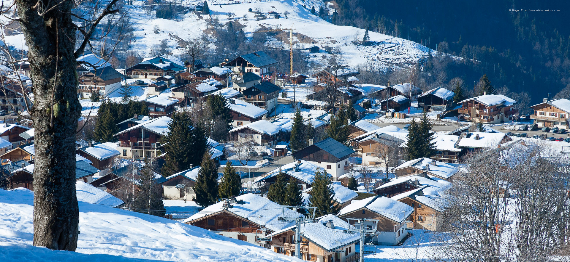 High view of snow-covered chalet rooftops at Crest Voland.