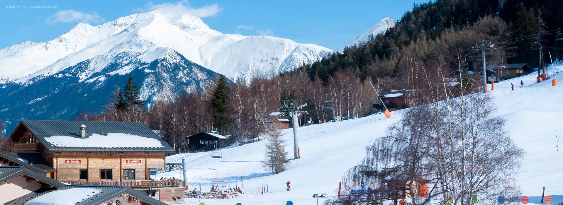 View of ski lifts, bar and mountains at La Norma