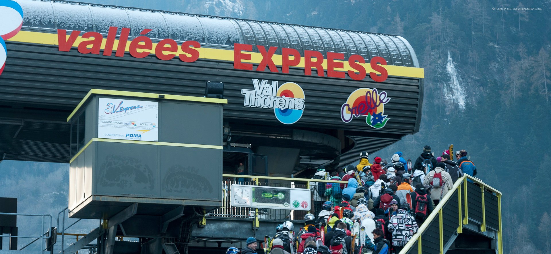 Skiers queueing to board gondola lift