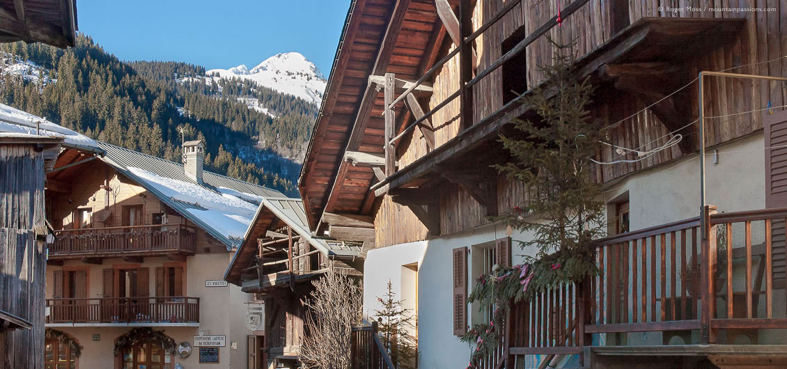 Traditional Savoyard chalets in Areches village, with snow-covered mountains