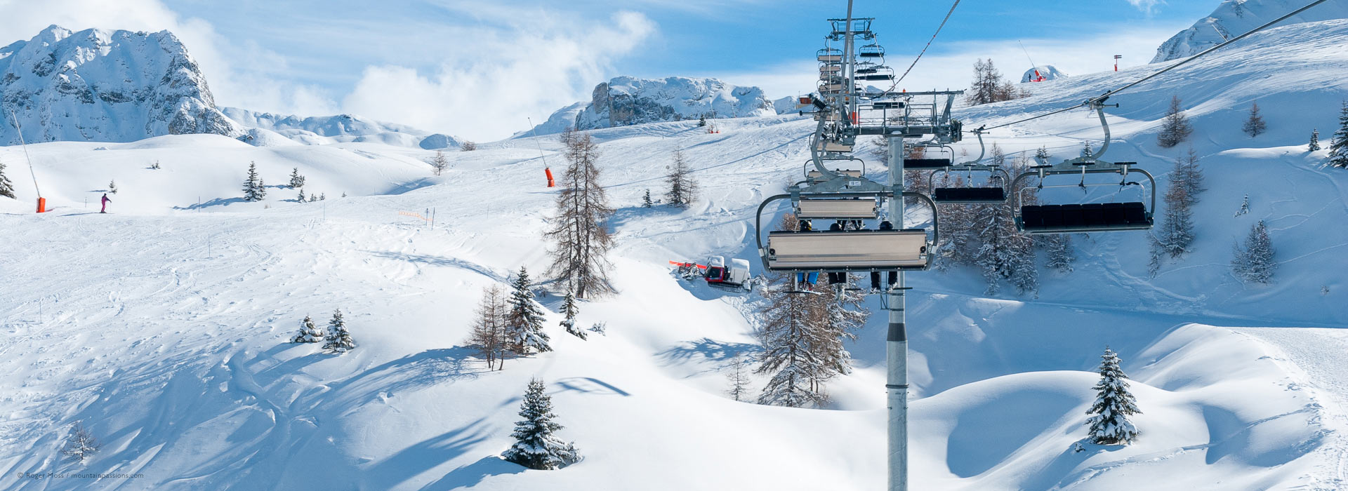 Wide overview from chairlift of pistes after fresh snow