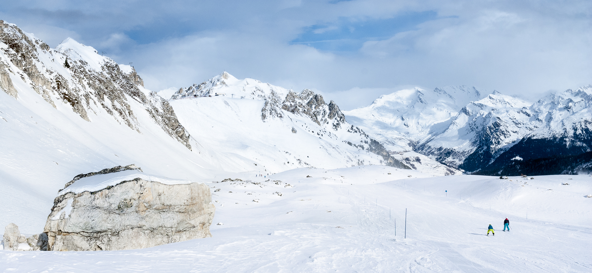 Two young skiers on wide piste above Les Arcs.