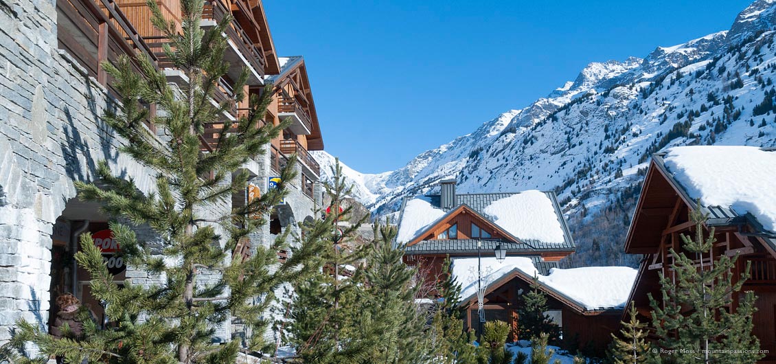 View through trees to village chalets and apartments