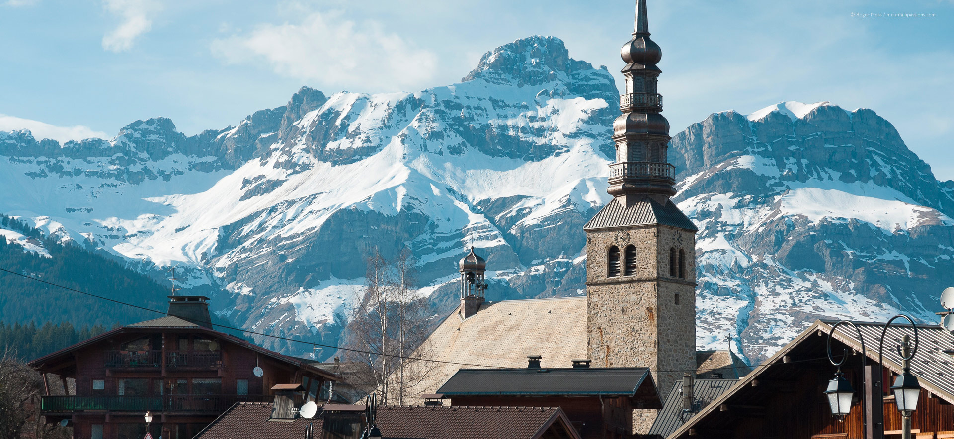 Chalet rooftops and village church at Combloux, with Mont Blanc in background.