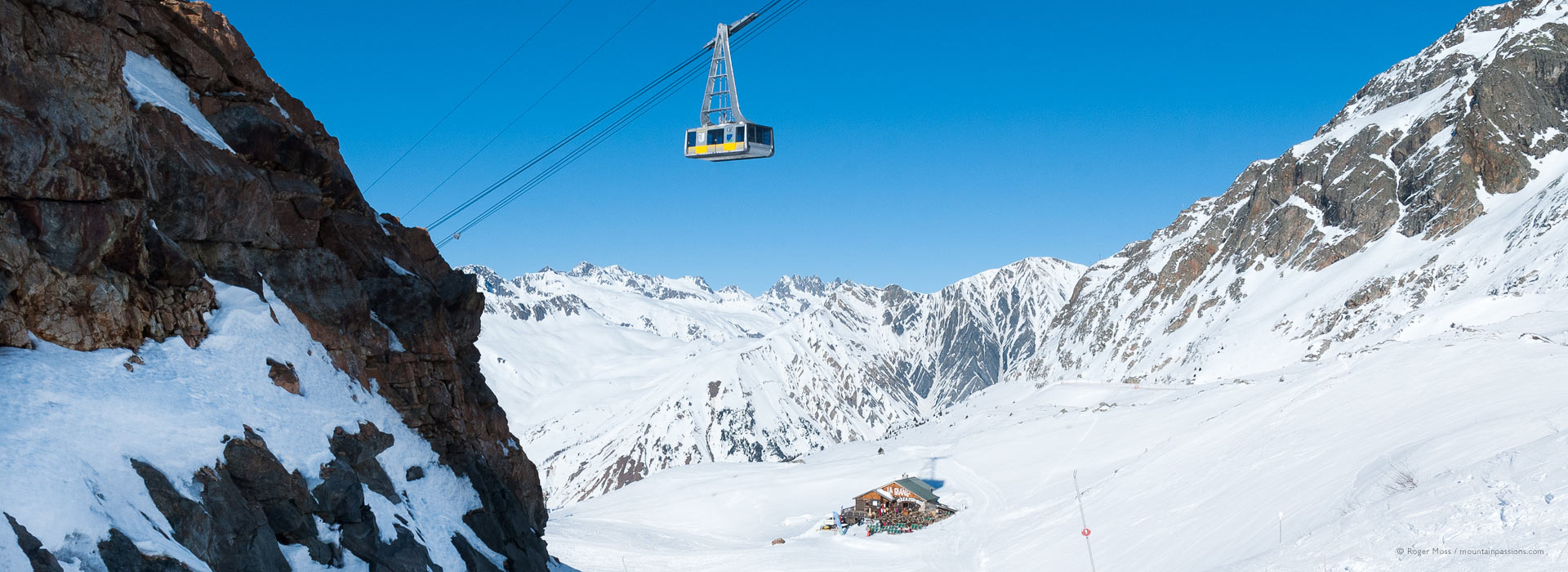 Wide view of mountains with cable car above Vaujany