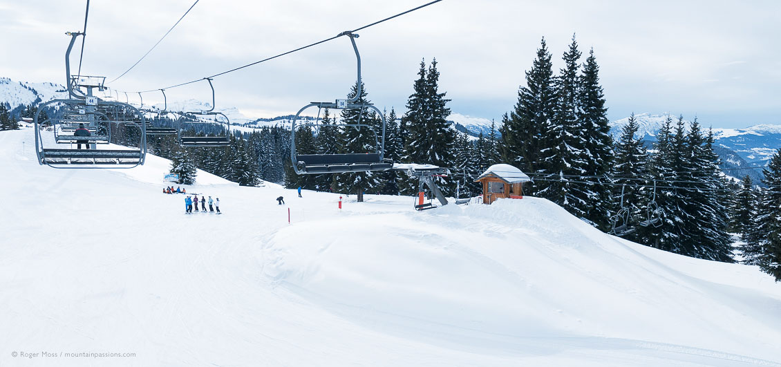 Chair lift view of mountainside with skiers at Morzine