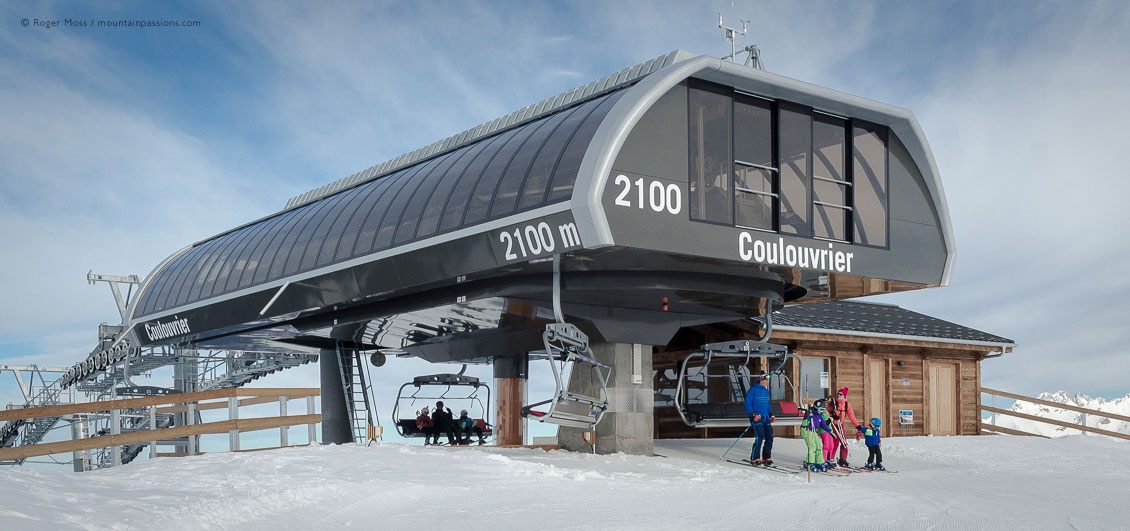 Family skiers leaving chairlift above Samoens, Grand Massif, French Alps